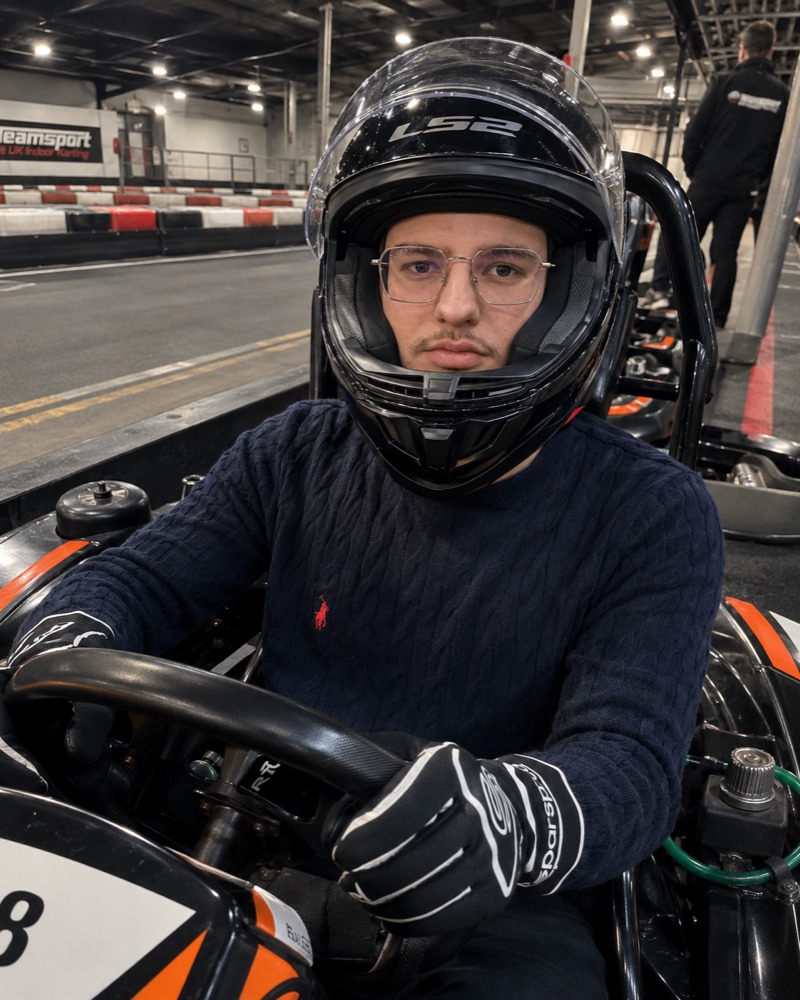 Emin in a go-kart, helmet on, before a race